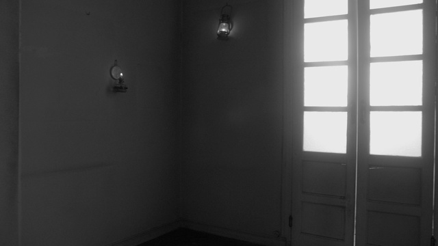 Video Reference N2: Black, Property, Room, Wall, Architecture, Black-and-white, Line, Door, House, Floor, Indoor, Window, White, Building, Small, Sitting, Sink, Light, Mirror, Lit, Large, Bed, Tub, Bathroom, Black and white, Shower, Plumbing fixture, Lamp, Curtain, Door handle, Monochrome, Tap, Window blind