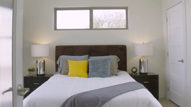 Video Reference N1: bedroom, room, property, bed frame, home, wall, real estate, interior design, window, bed
