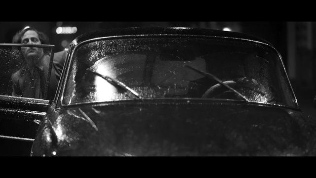 Video Reference N1: car, black, black and white, motor vehicle, monochrome photography, mode of transport, photography, automotive design, darkness, light, Person