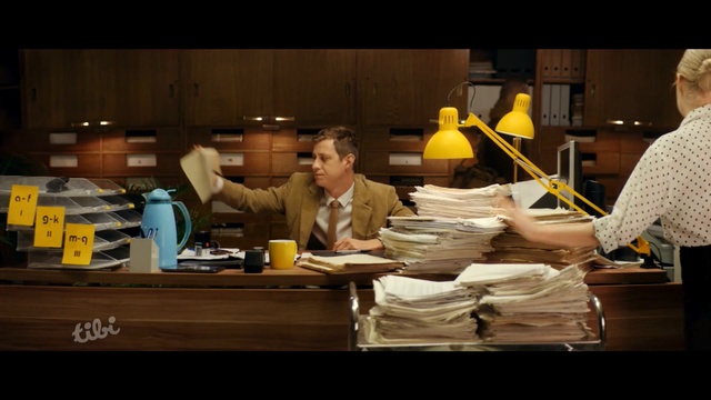 Video Reference N0: man, bookkeeping, lamp, paper, lot of paper, Person
