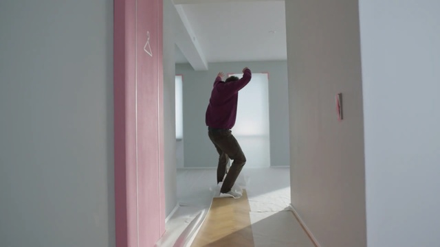 Video Reference N1: Pink, White, Red, Wall, Standing, Room, Shoulder, Floor, Footwear, Line, Indoor, Building, Door, Man, Open, Refrigerator, Mirror, Young, Kitchen, Trousers, Clothing, Person, Window
