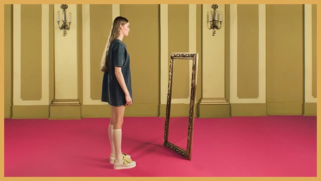 Video Reference N1: Yellow, Shoulder, Leg, Standing, Joint, Arm, Human body, Room, Floor, Knee, Person, Indoor, Woman, Man, Front, Young, Red, Holding, Building, Mirror, Girl, Wearing, Door, Phone, Suit, Walking, Playing, Rug, Suitcase, White, Wall, Footwear, Dress, Skirt, Clothing, Miniskirt, Handbag, Furniture
