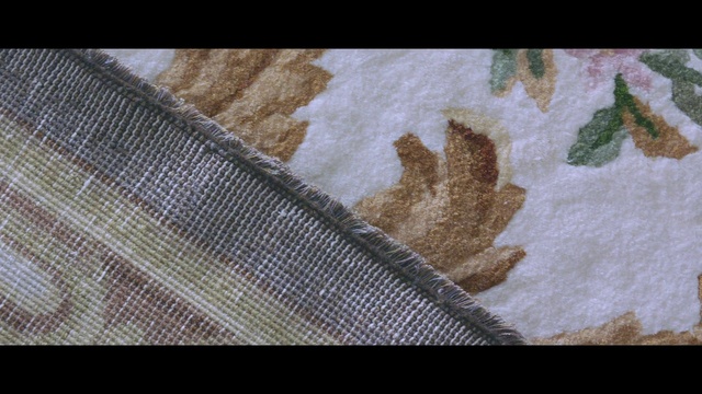 Video Reference N3: Leaf, Textile, Beige, Pattern, Linens, Table, Sitting, Small, Cake, Fabric, Food, Holding, Cut, Covered, Laying, Towel, Man, White, Rug, Cat, Colored