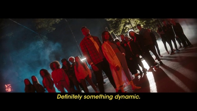 Video Reference N5: Red, Crowd, Font, Movie, Photography, Fictional character, Screenshot, Person, Indoor, Table, Sitting, Food, Cake, Group, Display, White, Room, Man, Text, Clothing, Poster, Dance
