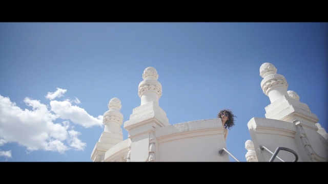 Video Reference N5: sky, statue, monument, landmark, cloud, sculpture, daytime, temple, sunlight, religion, Person