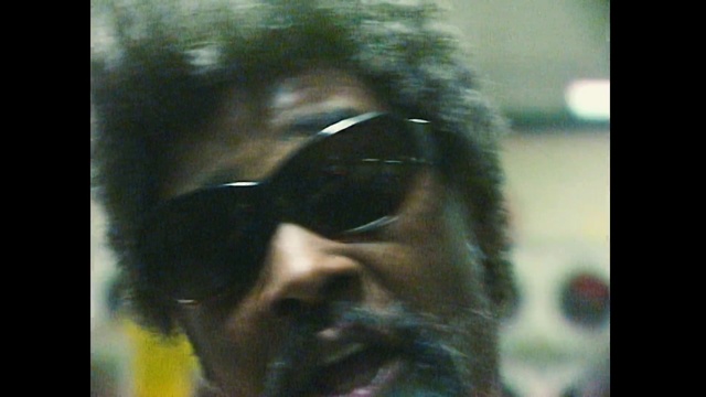 Video Reference N11: Hair, Eyewear, Face, Forehead, Head, Nose, Glasses, Sunglasses, Snapshot, Human, Person, Looking, Spectacles, Wearing, Front, Goggles, Photo, Standing, Man, Black, Close, Holding, Mirror, Woman, Screen, Reflection, White, Red, Teeth, Hat, Human face, Human beard, Clothing, Portrait, Staring