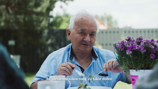 Video Reference N9: Flower, Botany, Plant, Grandparent, Adaptation, Garden, Leisure, Hydrangea, Person, Outdoor, Man, Table, Front, Holding, Older, Sitting, Food, Old, Woman, Glass, Blue, Standing, Plate, Phone, White, Cake, Vase, Parking, People, Sign, Shirt, Human face