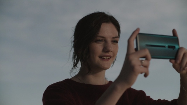 Video Reference N0: Hand, Gesture, Gun, Finger, Technology, Smile, Photography, Electronic device, Thumb, Person, Holding, Outdoor, Man, Standing, Young, Looking, Woman, Front, Surfing, Shirt, Wearing, Smiling, White, Beach, Water, Playing, Phone, Remote, Video, Ocean, Human face, Portrait, Face, Girl, Clothing, Appliance
