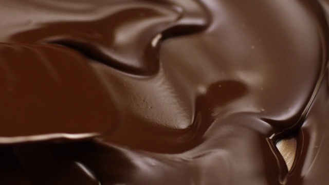Video Reference N0: Chocolate, Ganache, Brown, Close-up, Chocolate syrup, Dessert, Food, Dulce de leche, Caramel color, Chocolate pudding, Indoor, Sitting, Table, Black, Close, White, Mouse, Cake, Keyboard, Laying, Coffee, Plate, Design