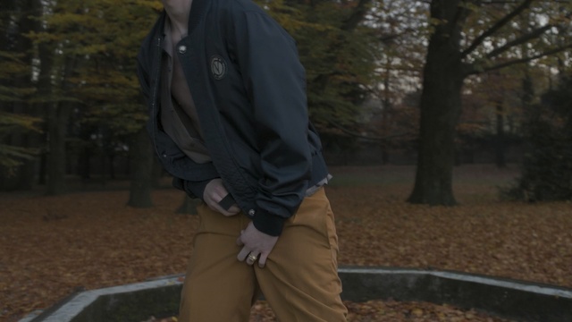 Video Reference N6: Soil, Tree, Outerwear, Jacket, Sitting, Leg, Human body, Footwear, Photography, Trousers