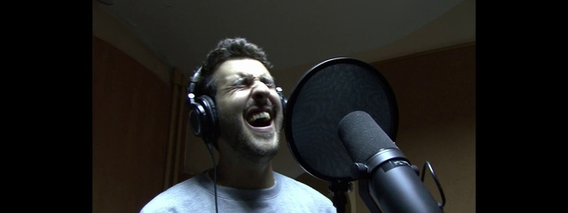 Video Reference N1: Microphone, Singing, Audio equipment, Singer, Music artist, Music, Recording studio, Electronic device, Technology, Microphone stand, Person, Indoor, Man, Holding, Front, Looking, Standing, Mirror, Wearing, Room, Shirt, Young, Hand, Face, Table, Head, Video, Black, Kitchen, White, Teeth, Computer, Playing, Brushing, Phone, Remote, Wall, Headphones, Human face