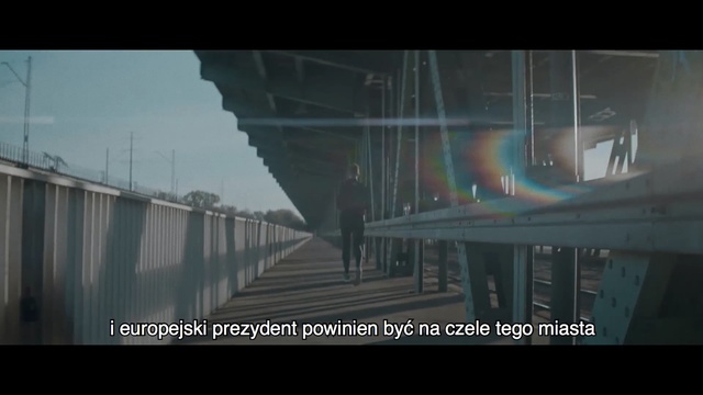 Video Reference N3: Bridge, Fixed link, Atmospheric phenomenon, Snapshot, Architecture, Mode of transport, Atmosphere, Overpass, Sky, Photography, Outdoor, Building, Sitting, Water, Table, Large, Glass, Street, Train, City, Light, Green, Bus, Holding, Rain, White, Man, Bird, Track, Standing, Traffic, Text, Screenshot, Fog, Video game