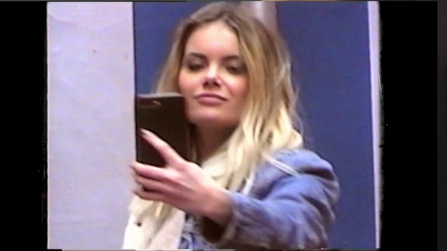 Video Reference N1: Hair, Blond, Face, Photograph, Facial expression, Head, Selfie, Beauty, Lady, Long hair, Person, Indoor, Window, Front, Woman, Young, Monitor, Man, Girl, Screen, Table, Shirt, Holding, Television, Using, Standing, Computer, White, Refrigerator, Pizza, Human face, Clothing, Text, Smile, Picture frame