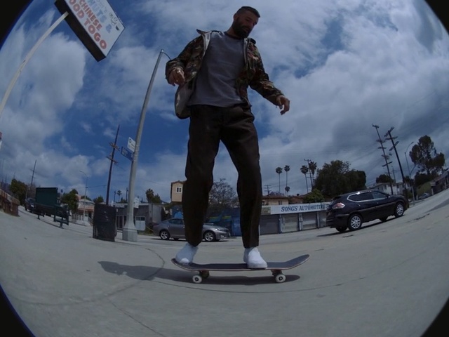 Video Reference N7: Skateboarder, Freebord, Skateboarding, Photography, Recreation, Fisheye lens, Skateboard, Skateboarding equipment, Sky, Sports equipment, Person, Outdoor, Road, Man, Riding, Standing, Young, Street, Wearing, Side, Mountain, Hill, Board, Cloudy, Game, Holding, Slope, Footwear, Snowboarding, Skate, Boardsport