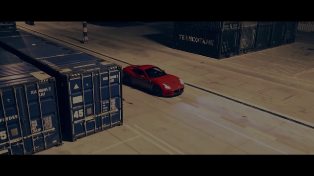 Video Reference N1: Land vehicle, Vehicle, Mode of transport, Car, Race car, Automotive design, Sports car, Performance car, Supercar, Screenshot, Indoor, Sitting, Room, Table, Man, Luggage, Large, Suitcase, Bed, Parked, Red, Board, Riding, Living, White, Airplane, Laying, Ramp, Plane, Floor, Wheel