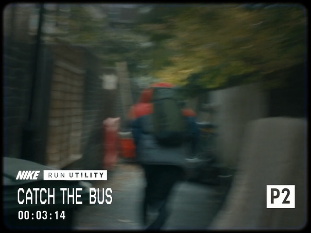 Video Reference N5: Mode of transport, Font, Darkness, Tree, Photo caption, Photography, Screenshot, Outdoor, Street, Sign, Riding, Photo, Black, City, Man, Blurry, Bus, Woman, Red, Holding, White, Rain, Road, Traffic, Standing, Phone, Tall, Text, Person, Clothing