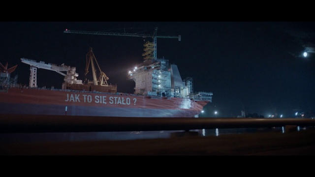 Video Reference N3: Vehicle, Ship, Watercraft, Boat, Battleship, Night, Heavy cruiser, Naval ship, Naval architecture, Warship, Indoor, Window, Table, Large, Monitor, Sitting, Building, Front, Television, Screen, View, Room, Light, Computer, Desk, Bridge, Man, White, Standing, Text