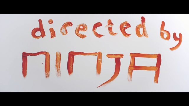 Video Reference N1: text, red, font, orange, calligraphy, brand, graphic design, angle, logo, Person