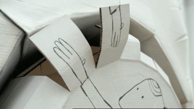 Video Reference N4: cardboard, design, paper, font, angle, material, product, box, carton, Person