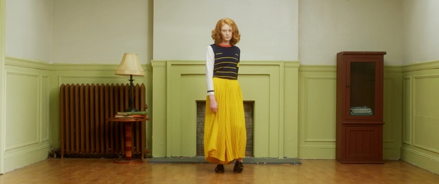 Video Reference N0: clothing, yellow, dress, standing, room, shoulder, girl, outerwear, floor, joint