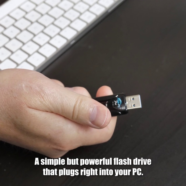 Video Reference N1: Technology, Finger, Electronic device, Electronics, Usb flash drive, Cable, Gadget, Electronic component, Keyboard, Computer, Hand, Man, Black, Sitting, Holding, Laptop, Using, Phone, Desk, White, Text, Screenshot, Mobile phone, Computer keyboard, Input device, Portable communications device