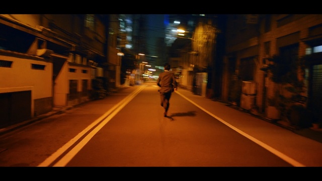 Video Reference N0: night, yellow, urban area, lane, infrastructure, street, light, darkness, road, snapshot, Person