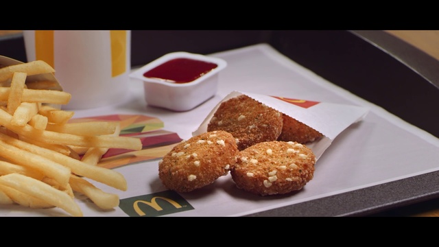 Video Reference N0: Dish, Food, Cuisine, Ingredient, Junk food, Fast food, Chicken nugget, Finger food, Fried food, Comfort food, Table, Indoor, Plate, Fries, Photo, Sitting, Tray, Topped, Different, Fruit, White, Sandwich, Baked goods, Dessert, Chocolate, Snack, Cake, Delicious, Bread, Croquette, Recipe, Arancini, Sata andagi, Cookie, Chicken balls, Korokke, Muffin, Bakery, Tasty, Breakfast, Sweet, Doughnut, Hushpuppy, Fritter, Pastry, Falafel, Deep frying