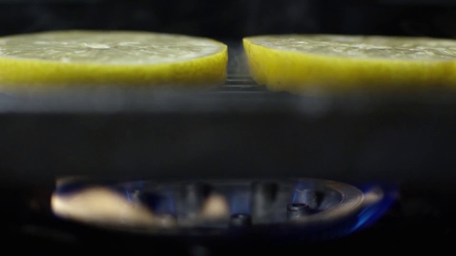 Video Reference N3: Water, Yellow, Drink, Food, Photography, Indoor, Sitting, Table, Front, Black, Close, Fruit, Orange, Banana, Laying, Remote, Red, Blue, Cat, Plate, Lemon