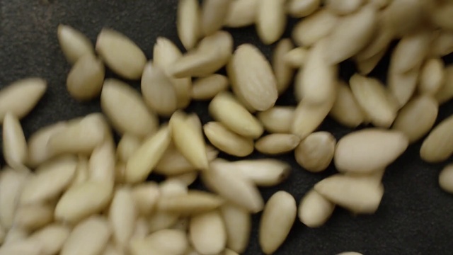Video Reference N0: Pine nut, Food, Cuisine, Vegetarian food, Plant, Ingredient, Seed, Produce, Sunflower seed, Navy beans, Nut, Fruit, Sitting, Pile, Topped, Chocolate, Banana, Several, Plate, Fries, Table, Covered, White, Group, Nuts & seeds, Sliced, Vegetable