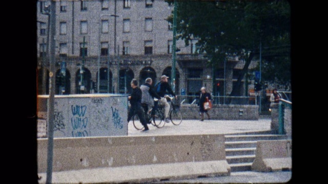 Video Reference N1: Snapshot, Urban area, Public space, Wall, Pedestrian, Street, Photography, Sitting, City, Architecture