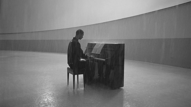 Video Reference N3: Musical instrument, Piano, Keyboard, Musician, Pianist, Standing, Black-and-white, Grey, Style, Art