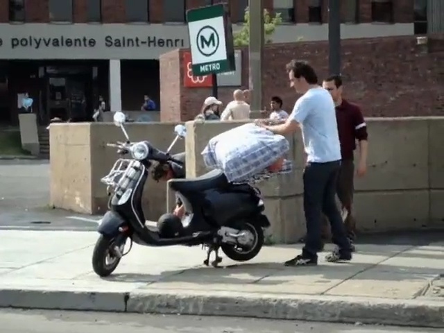 Video Reference N1: scooter, motorcycling, motor vehicle, mode of transport, product, vespa, vehicle, moped, motorcycle, street, Person