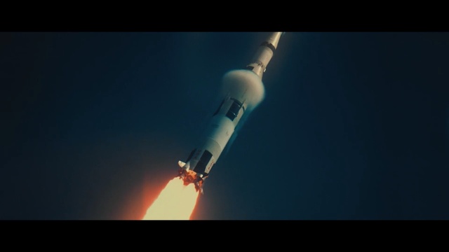 Video Reference N1: Rocket, Spacecraft, Space shuttle, Atmosphere, Sky, Vehicle, Space, Heat, Dark, Man, Light, Large, Airplane, Holding, Flying, White, Air, Plane, Television, Standing, Blue, Red, Room, Night, Screenshot, Flight