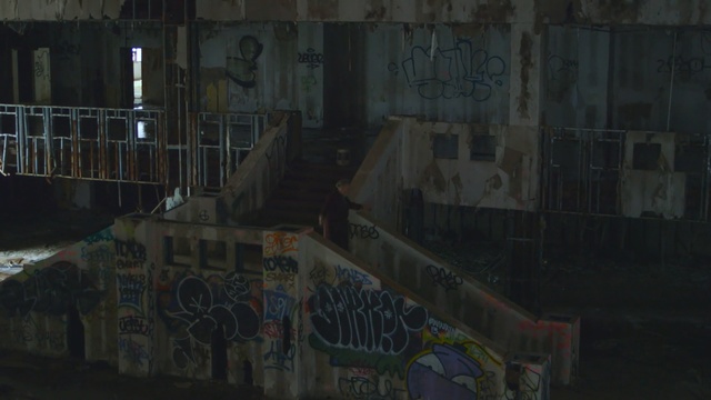 Video Reference N0: urban area, wall, night, structure, graffiti, area, darkness, street, road, facade
