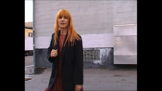 Video Reference N1: Clothing, Hair, Photograph, Street fashion, Dress, Outerwear, Fashion, Lady, Snapshot, Standing, Person, Building, Woman, Outdoor, Front, Young, Sidewalk, Holding, Wearing, Black, Girl, Man, Street, Suit, Shirt, Walking, Red, Suitcase, Phone, Large, Umbrella, Coat, Jacket, Human face, Handbag, Skirt, Scarf, Fashion accessory, Smile, Luggage and bags