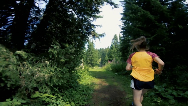 Video Reference N4: People in nature, Nature, Trail, Green, Jungle, Forest, Natural environment, Tree, Vegetation, Outdoor recreation, Outdoor, Person, Grass, Woman, Girl, Young, Riding, Yellow, Game, Frisbee, Field, Walking, Standing, Throwing, Shirt, Holding, Playing, Wearing, Park, Grassy, Street, Ball, Red, Catch, Clothing, Hiking, Plant, Wooded