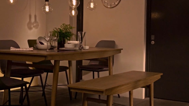 Video Reference N1: table, furniture, dining room, room, chair, interior design, light fixture, lighting, restaurant, Person