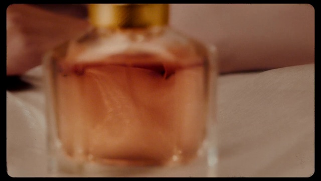 Video Reference N1: Skin, Close-up, Hand, Finger, Mouth, Perfume, Photography, Glass bottle, Fluid, Alcohol