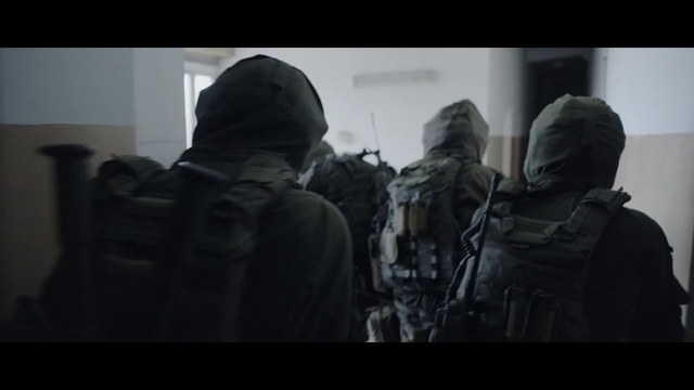 Video Reference N1: People, Military, Soldier, Army, Outerwear, Troop, Headgear, Military organization, Photography, Jacket, Indoor, Man, Looking, Room, White, Door, Black, Standing, Mirror, Holding, Woman, Large, Living, Bed, Clothing, Screenshot, Person, Weapon