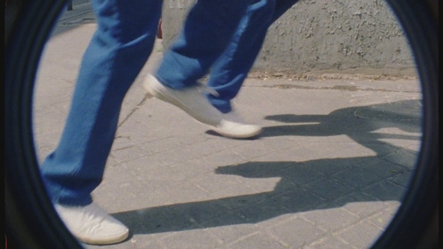 Video Reference N0: blue, footwear, shoe, leg, foot, shadow, asphalt, tire, automotive tire, human leg