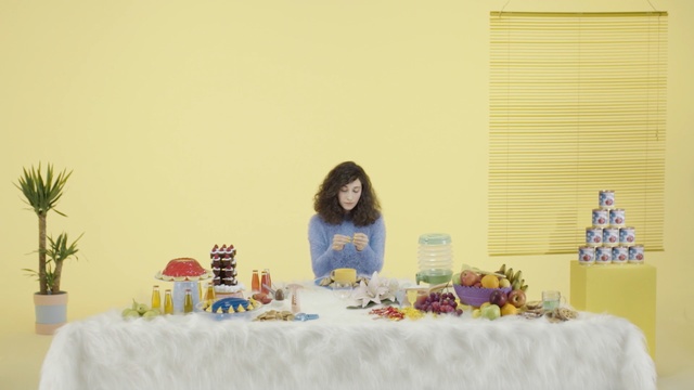 Video Reference N3: yellow, table, interior design, Person