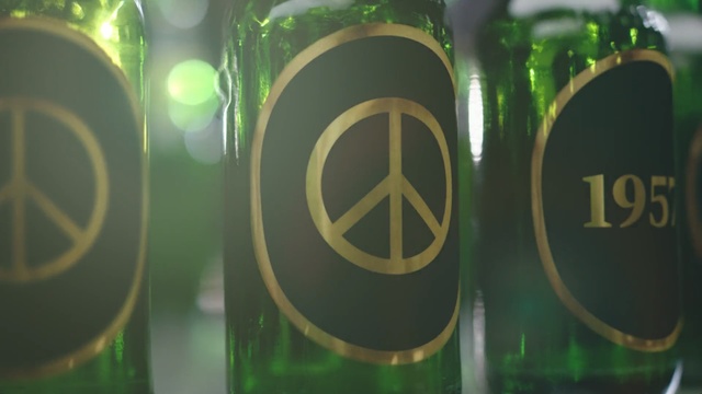 Video Reference N2: Green, Bottle, Yellow, Glass bottle, Drink, Font, Circle, Number, Symbol, Logo