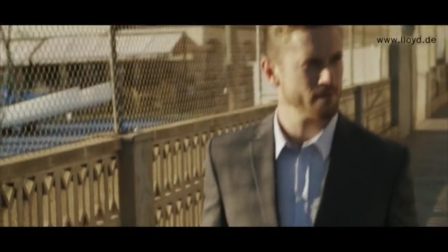 Video Reference N1: screenshot, film, official, suit, gentleman, photo caption, building