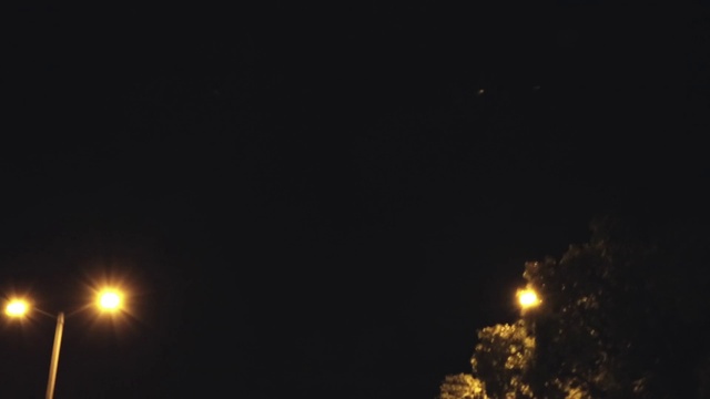Video Reference N9: Brown, Automotive lighting, Street light, Electricity, Sky, Midnight, Astronomical object, Darkness, Space, Event
