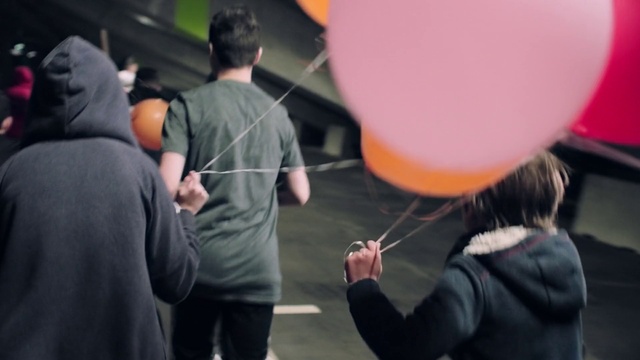 Video Reference N3: Outerwear, Gesture, Balloon, Event, T-shirt, Recreation, Crowd, Leisure, Party supply, Fun
