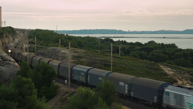 Video Reference N8: Train, Sky, Plant, Water, Cloud, Vehicle, Highland, Rolling stock, Land lot, Tree