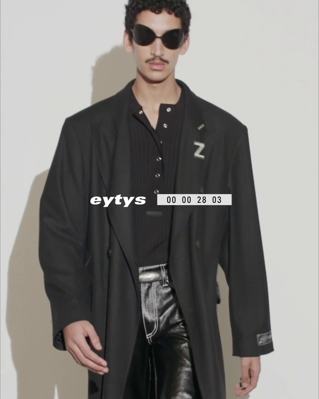 Video Reference N9: Face, Outerwear, Black, Fashion, Dress shirt, Neck, Street fashion, Sleeve, Overcoat, Waist