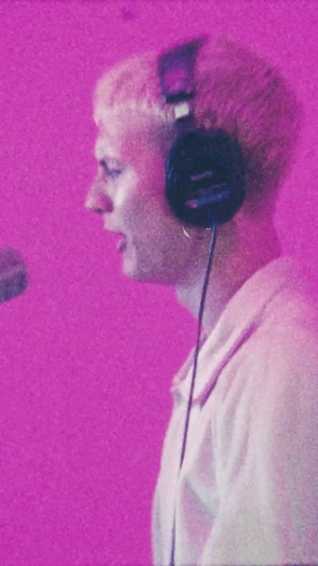 Video Reference N13: Chin, Microphone, Hairstyle, Hearing, Purple, Ear, Human body, Peripheral, Pink, Audio equipment