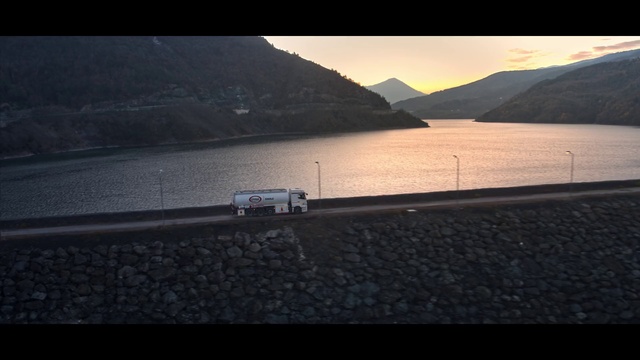 Video Reference N3: Water, Water resources, Sky, Mountain, Vehicle, Body of water, Car, Coastal and oceanic landforms, Lake, Dusk