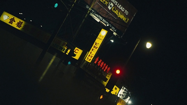 Video Reference N4: Amber, Automotive lighting, Font, Electricity, City, Building, Metropolis, Midnight, Space, Signage